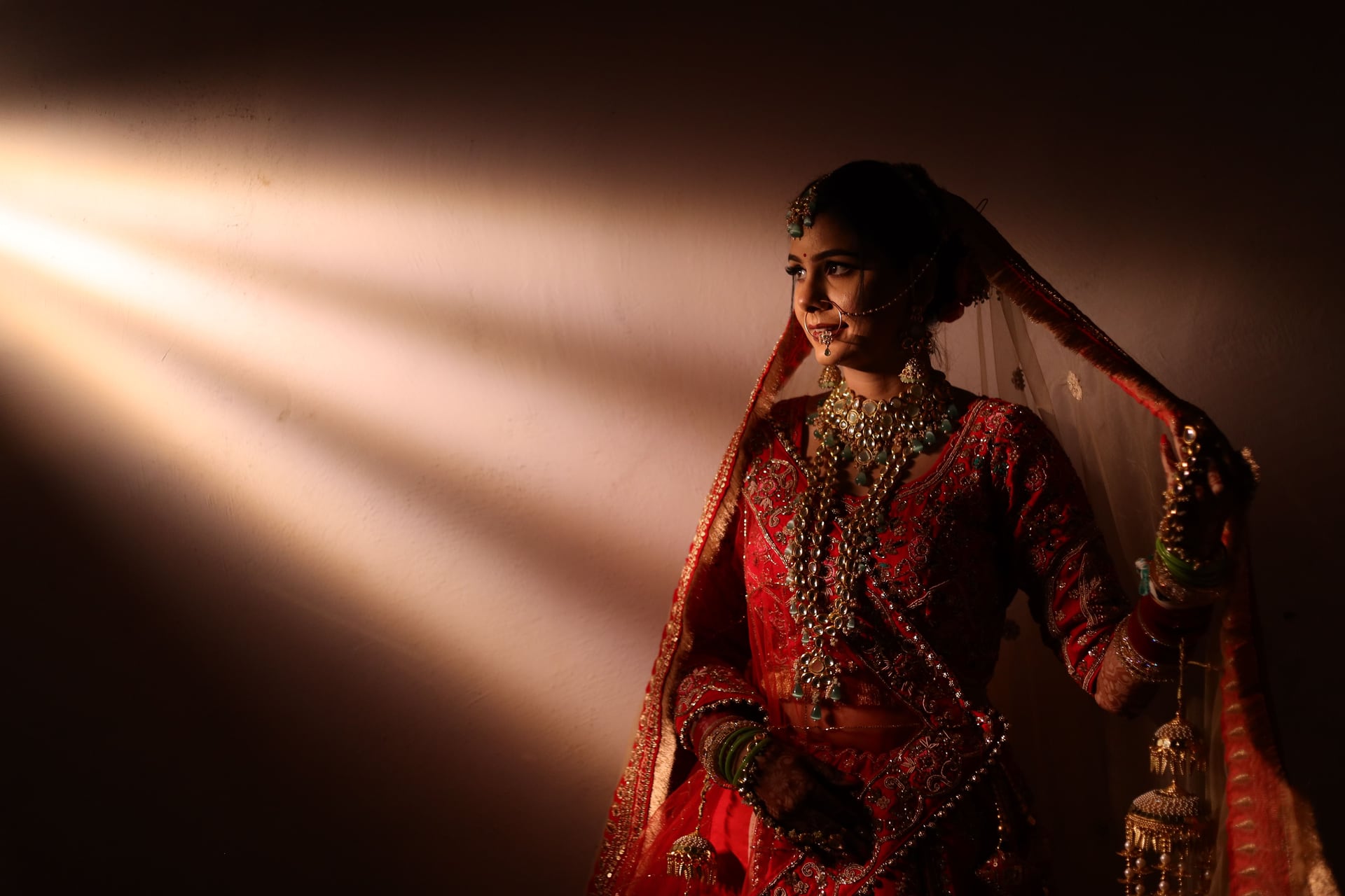 Bride in red wedding attire in warm evening light